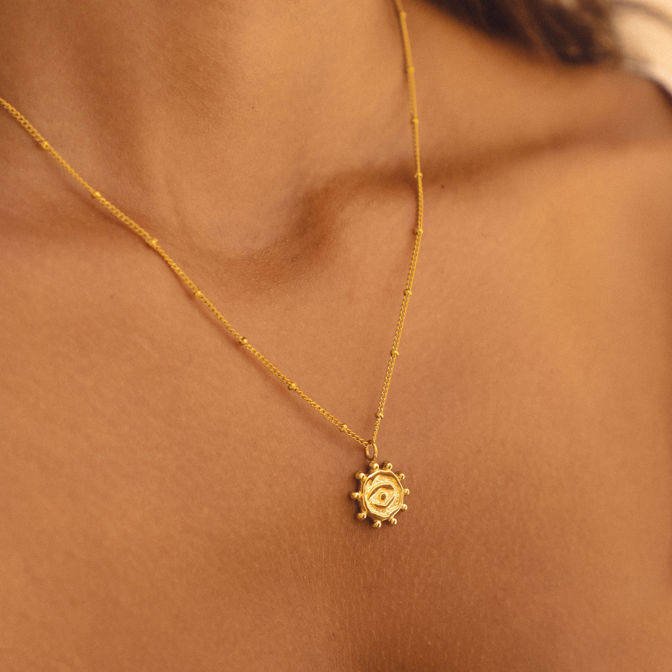 Gold evil eye pendant